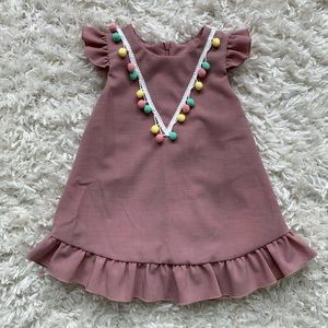 Baby dress with ruffle sleeve and pompoms